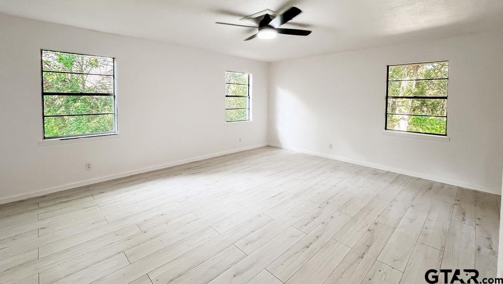 439 Lone Star Lane Hideaway, TX 75771 - Photo 30 of 36 wooden floor in an empty room with a window