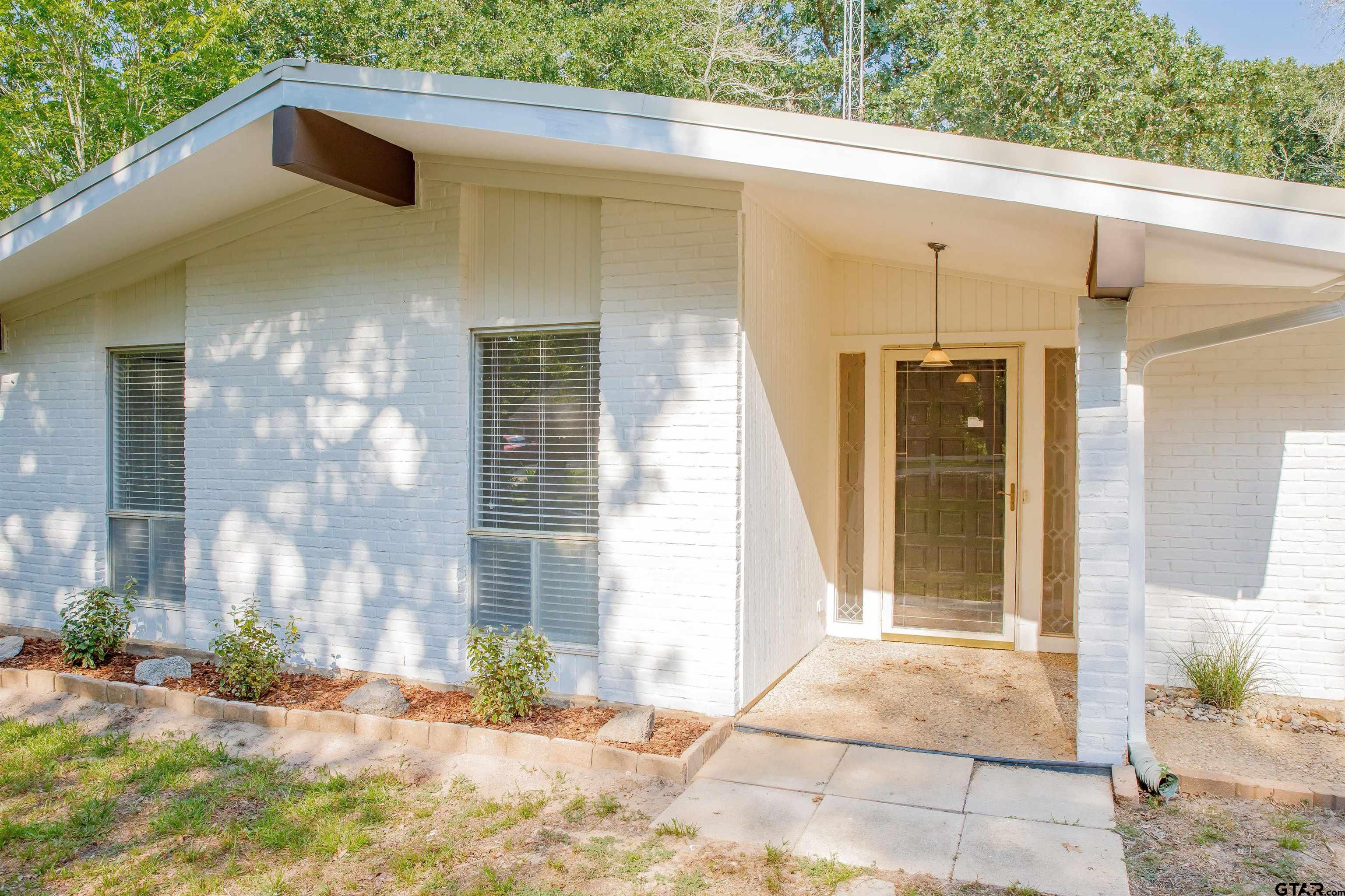 439 Lone Star Lane Hideaway, TX 75771 - Photo 3 of 36 a front view of a house with a yard