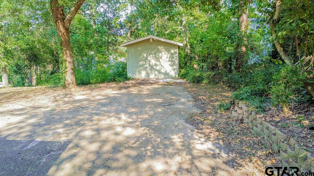 439 Lone Star Lane Hideaway, TX 75771 - Photo 33 of 36 a view of a house with a yard and large trees