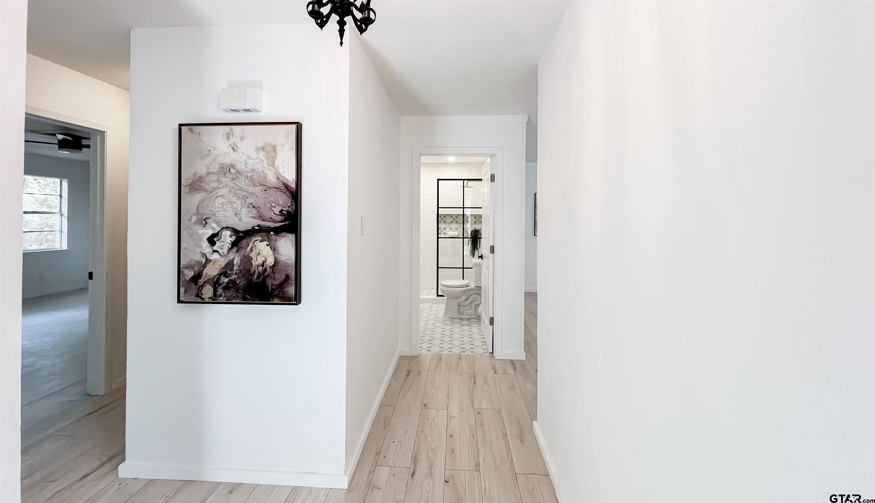 439 Lone Star Lane Hideaway, TX 75771 - Photo 8 of 36 a view of a hallway with wooden floor and closet