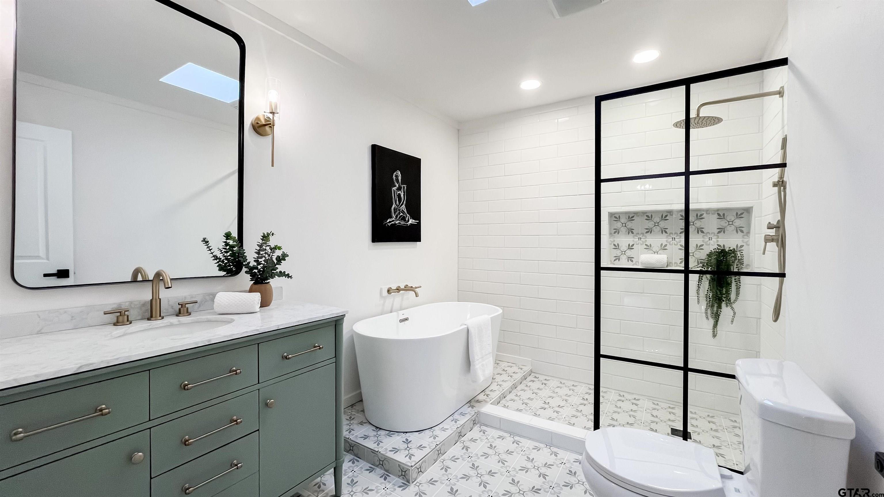 439 Lone Star Lane Hideaway, TX 75771 - Photo 9 of 36 a bathroom with a double vanity sink toilet and mirror