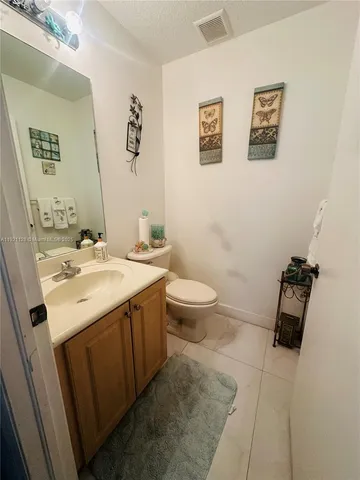 a bathroom with a sink toilet and vanity