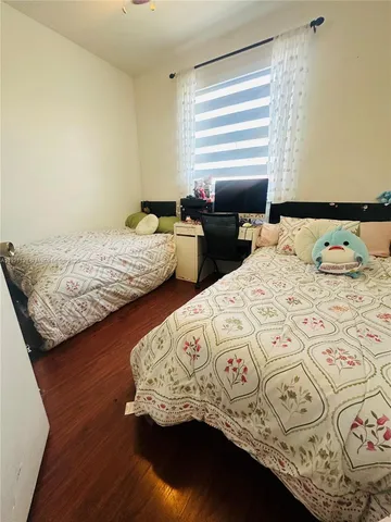 a bedroom with two beds next to a window