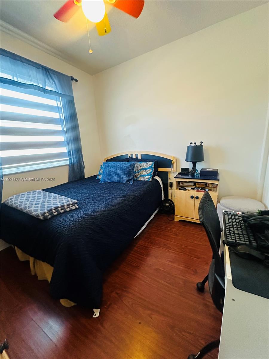 14343 Southwest 10th Street, Unit 2305 Pembroke Pines, FL 33027 - Photo 23 of 29 a bed sitting in a bedroom next to a window