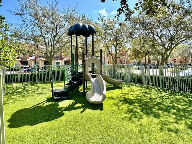 a swimming pool with outdoor seating yard and palm tree