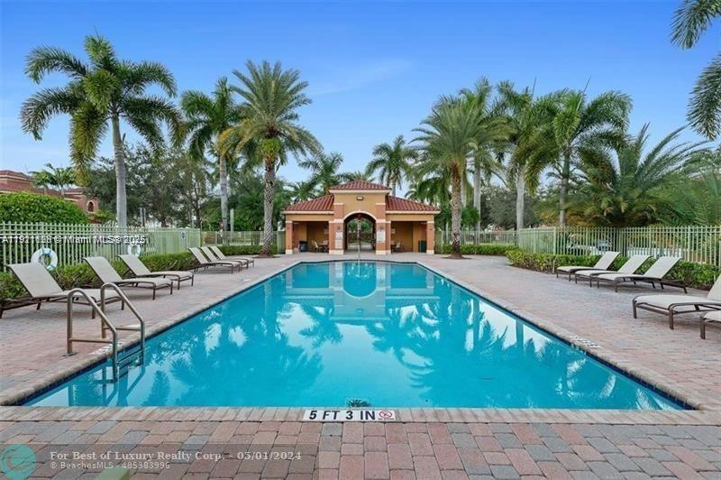 14343 Southwest 10th Street, Unit 2305 Pembroke Pines, FL 33027 - Photo 29 of 29 a swimming pool with outdoor seating yard and palm tree