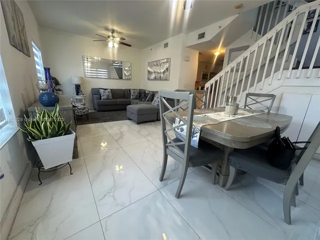 a living room with furniture and a mirror