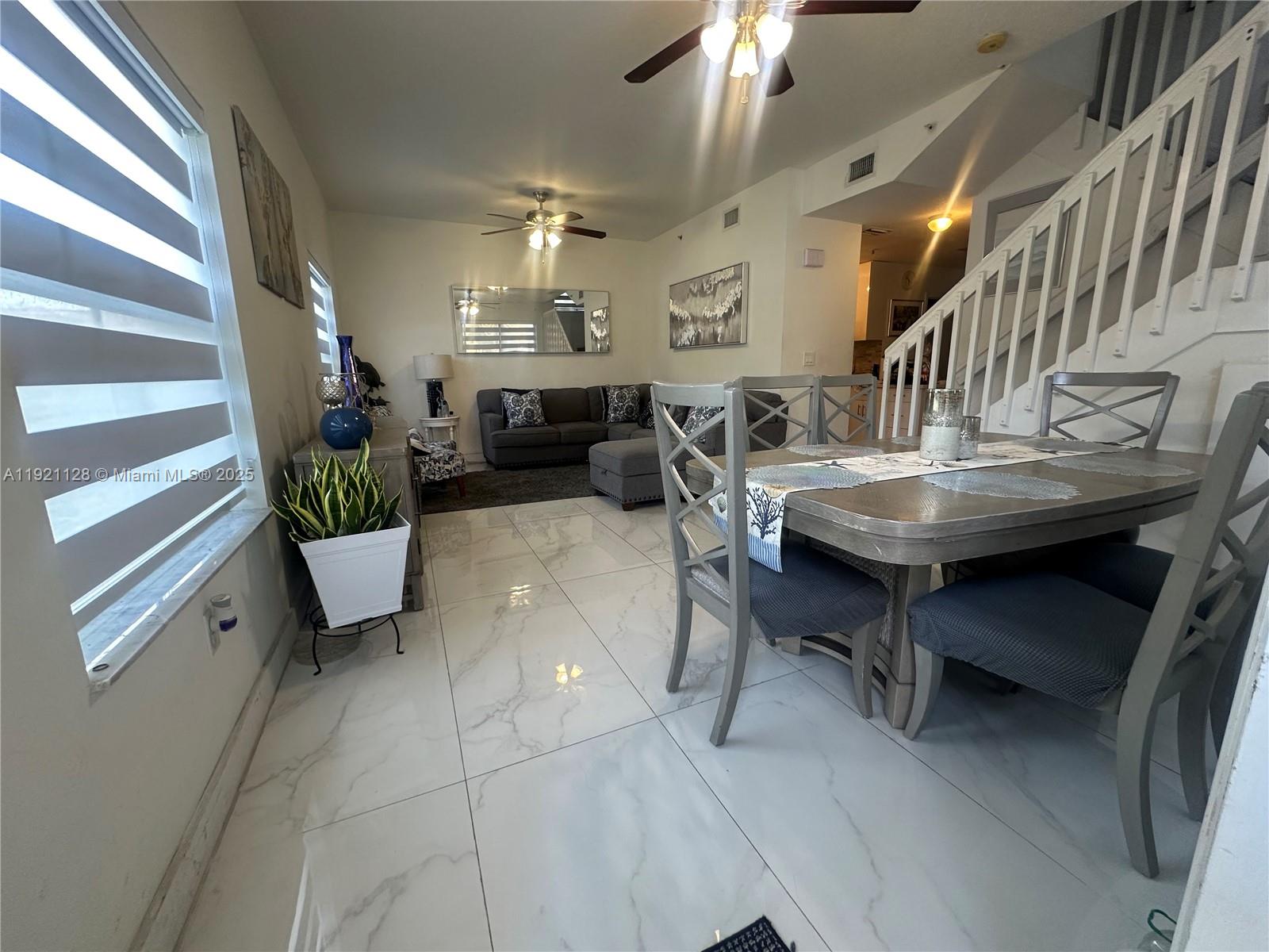 14343 Southwest 10th Street, Unit 2305 Pembroke Pines, FL 33027 - Photo 7 of 29 a living room with furniture and a table