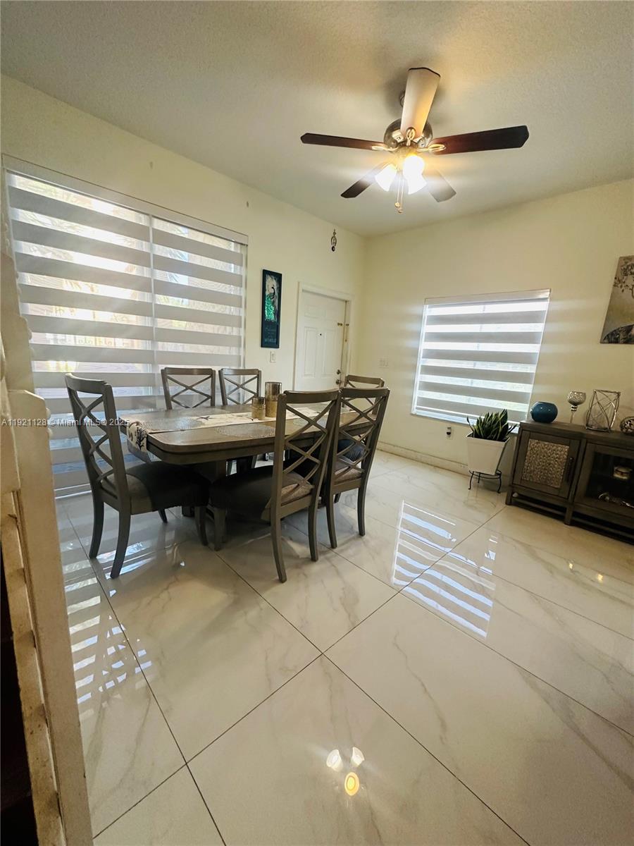 14343 Southwest 10th Street, Unit 2305 Pembroke Pines, FL 33027 - Photo 9 of 29 a view of a dining room with furniture and window
