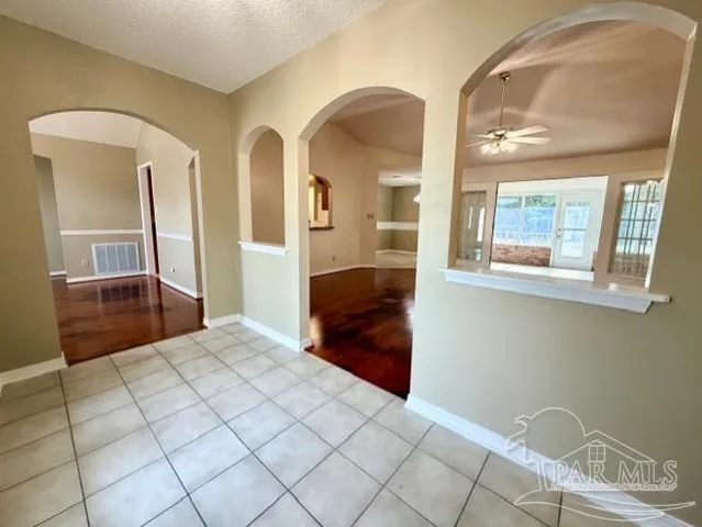 a view of empty room with wooden floor and fireplace