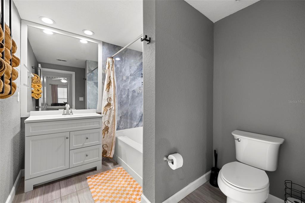 2410 West Azeele Street, Unit 214 Tampa, FL 33609 - Photo 14 of 24 a bathroom with a toilet sink and mirror