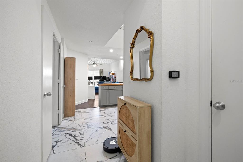 2410 West Azeele Street, Unit 214 Tampa, FL 33609 - Photo 3 of 24 a kitchen with kitchen island a sink stainless steel appliances and cabinets