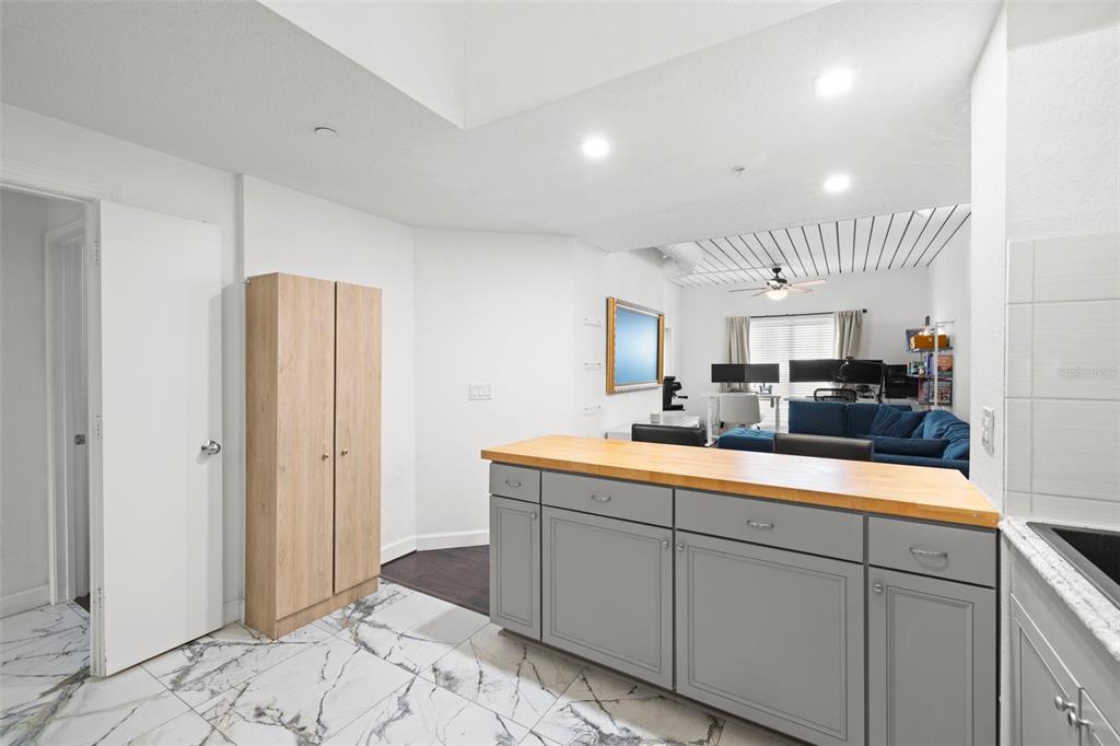 2410 West Azeele Street, Unit 214 Tampa, FL 33609 - Photo 6 of 24 a kitchen with white cabinets and sink