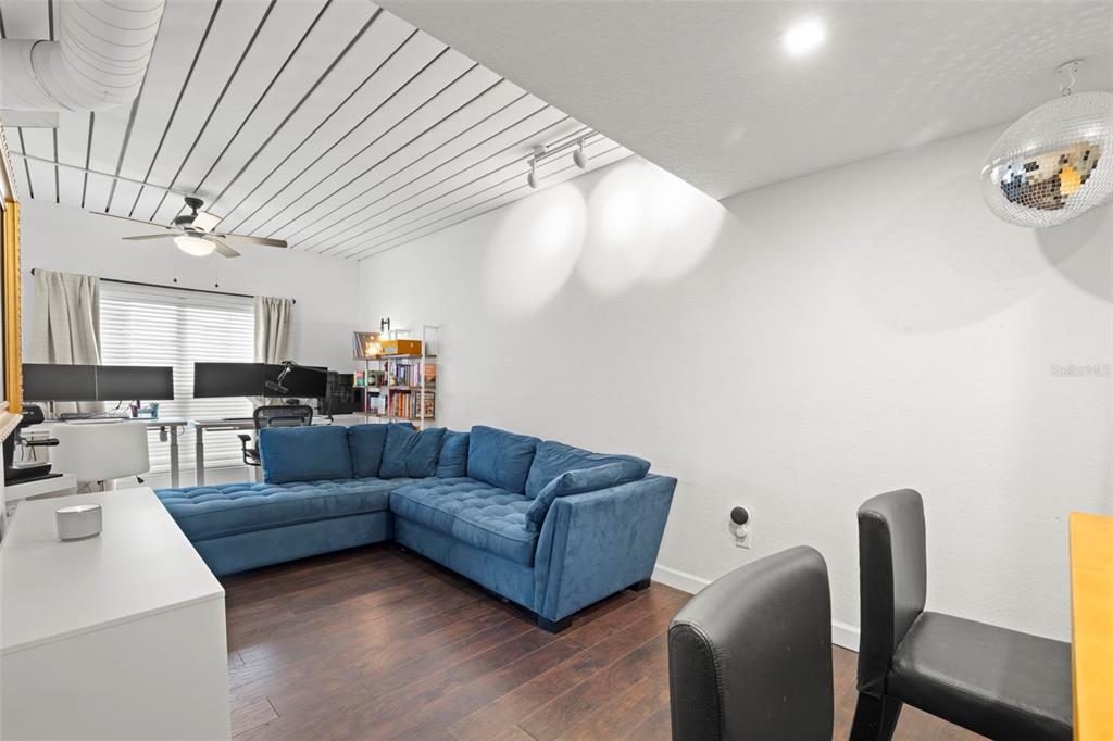 2410 West Azeele Street, Unit 214 Tampa, FL 33609 - Photo 8 of 24 a living room with furniture and a wooden floor