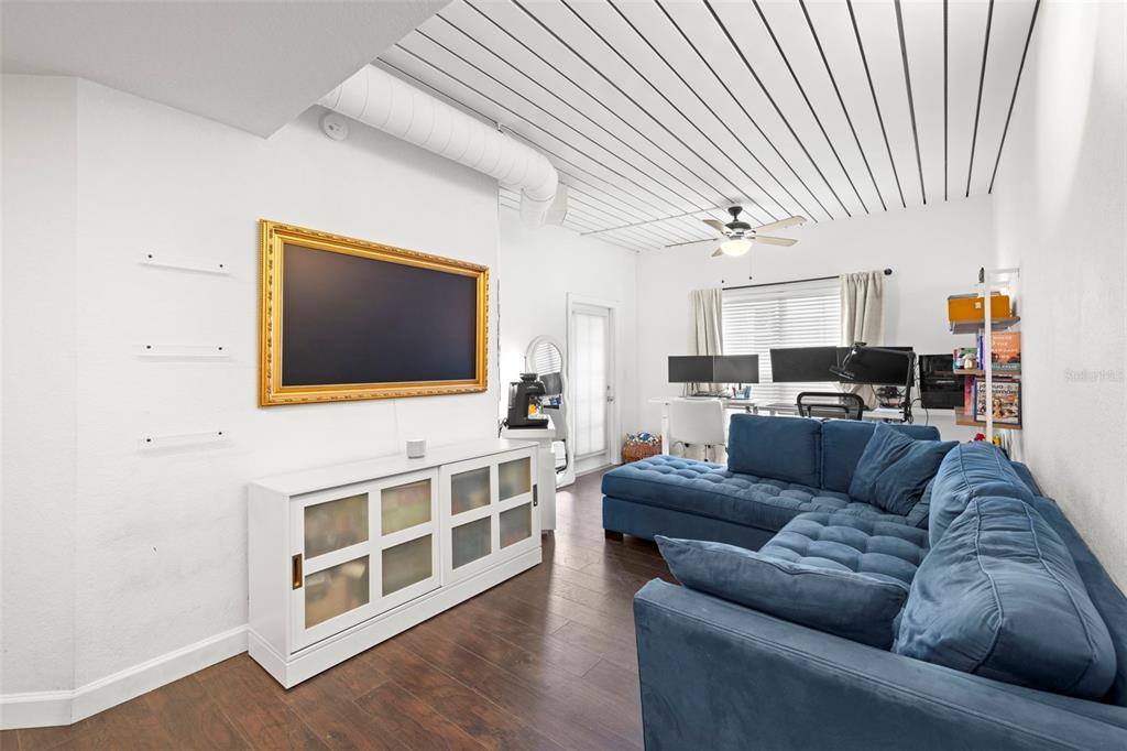 2410 West Azeele Street, Unit 214 Tampa, FL 33609 - Photo 9 of 24 a living room with furniture and a flat screen tv