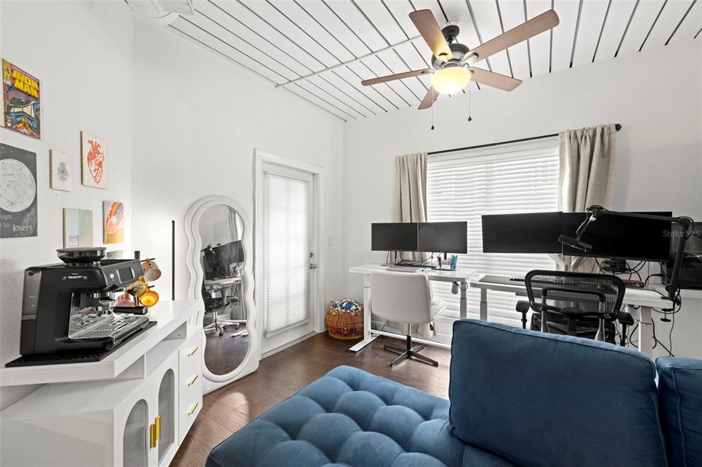 2410 West Azeele Street, Unit 214 Tampa, FL 33609 - Photo 10 of 24 a living room with furniture a flat screen tv and a fireplace