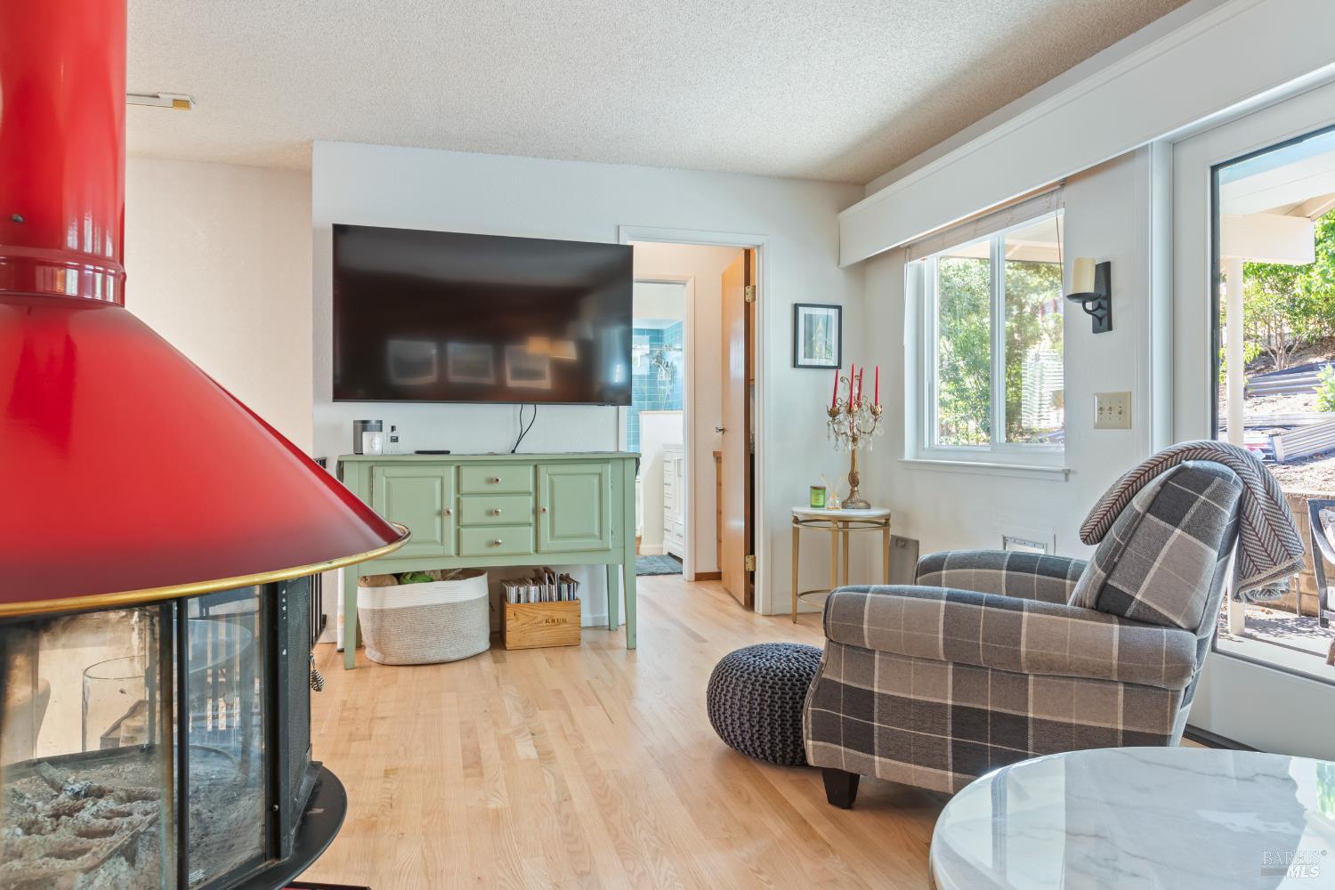 410 Oak Mesa Court Santa Rosa, CA 95409 - Photo 12 of 41 a living room with furniture a flat screen tv and floor to ceiling window