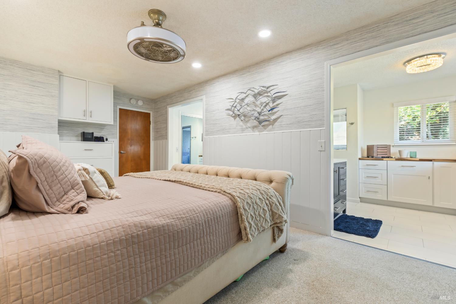 410 Oak Mesa Court Santa Rosa, CA 95409 - Photo 20 of 41 a bedroom with a bed and a chandelier