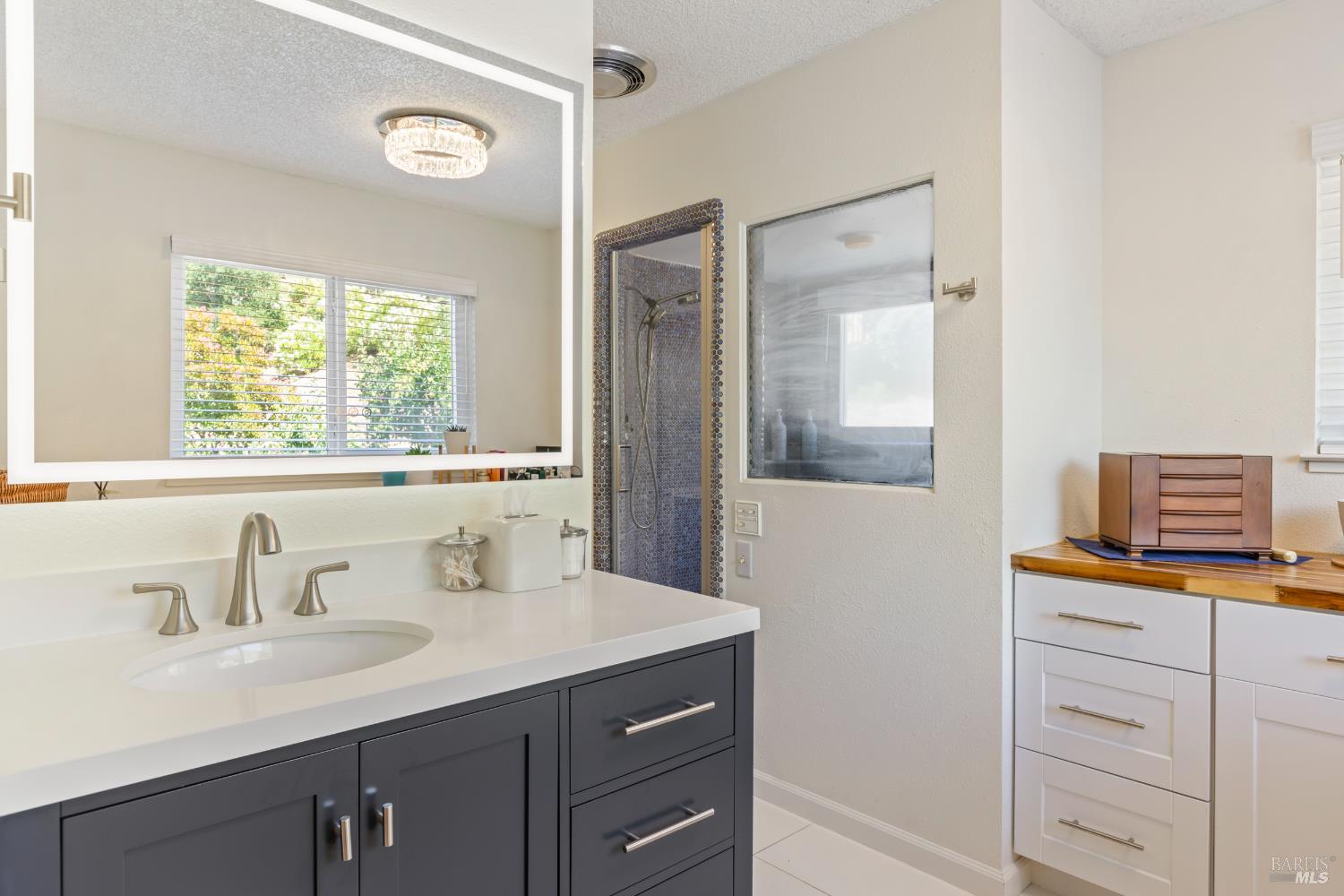 410 Oak Mesa Court Santa Rosa, CA 95409 - Photo 21 of 41 a bathroom with a sink and a mirror