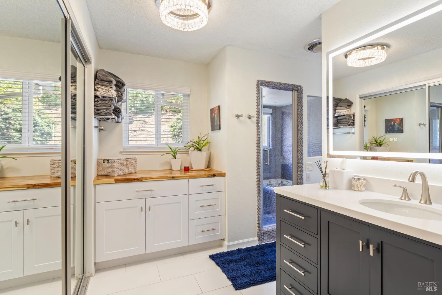 410 Oak Mesa Court Santa Rosa, CA 95409 - Photo 22 of 41 a bathroom with a sink vanity granite tub and a mirror