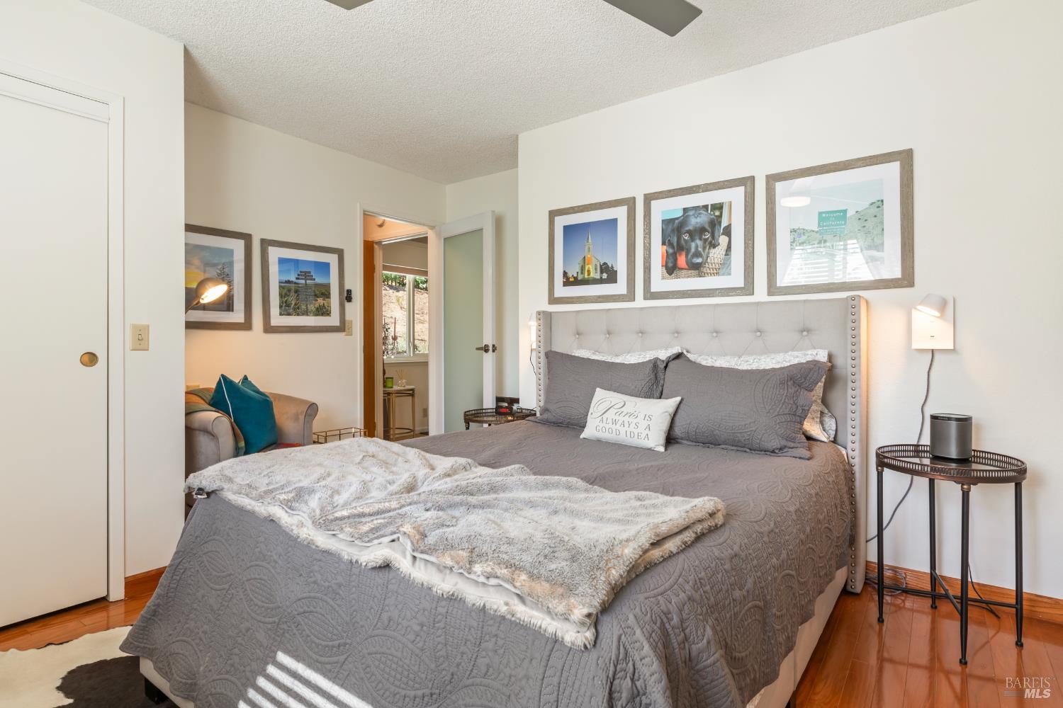 410 Oak Mesa Court Santa Rosa, CA 95409 - Photo 27 of 41 a bedroom with a large bed and a painting on the wall