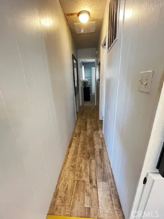 a view of a hallway with wooden floor
