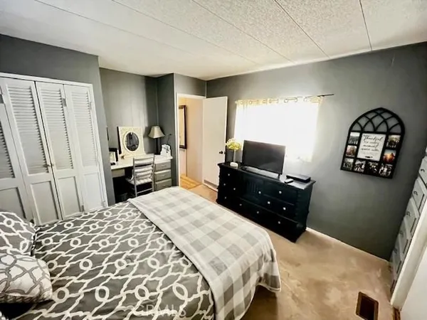a bedroom with a bed and a television
