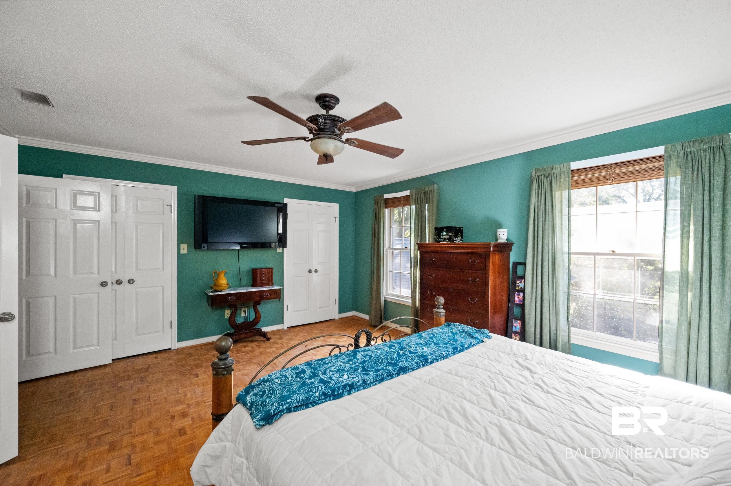 6705 Ridgeland Road South Mobile, AL 36695 - Photo 23 of 44 Bedroom with ceiling fan, crown molding, a textured ceiling, and parquet floors