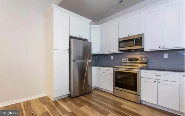 a kitchen with a refrigerator stove and microwave
