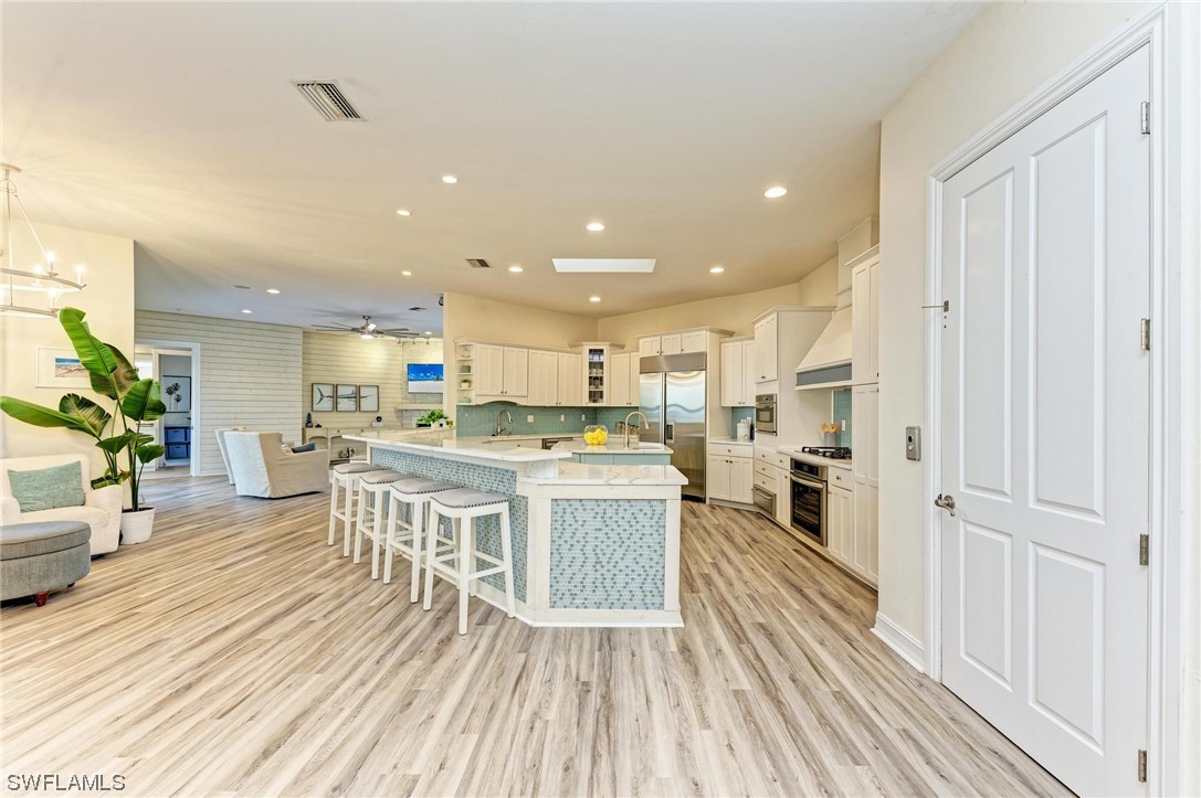 144 Riverview Road Fort Myers, FL 33905 - Photo 24 of 50 a living room with stainless steel appliances furniture wooden floor and a kitchen view