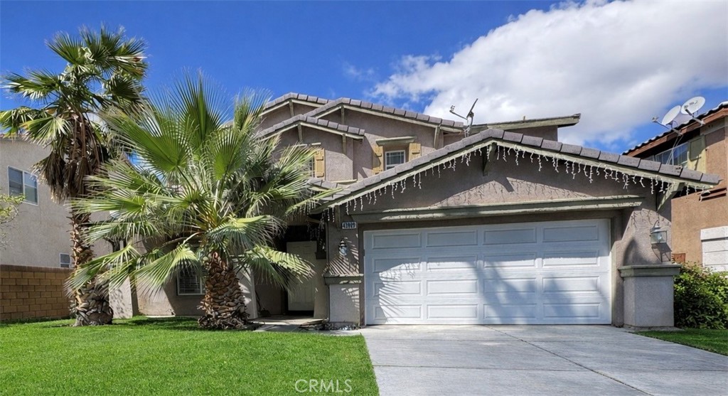 43009 23rd Street West Lancaster, CA 93536 - Photo 1 of 2 a front view of a house with a garden