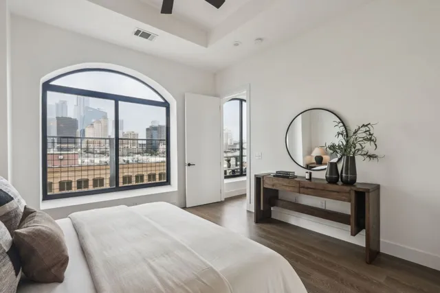 a bedroom with a large bed and a large window
