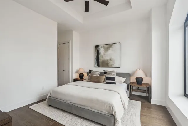 a bedroom with bed and a large window