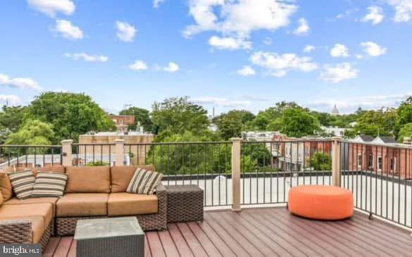 1209 G Street Southeast, Unit 2 Washington, DC 20003 - Photo 14 of 15 a balcony with wooden floor and fence