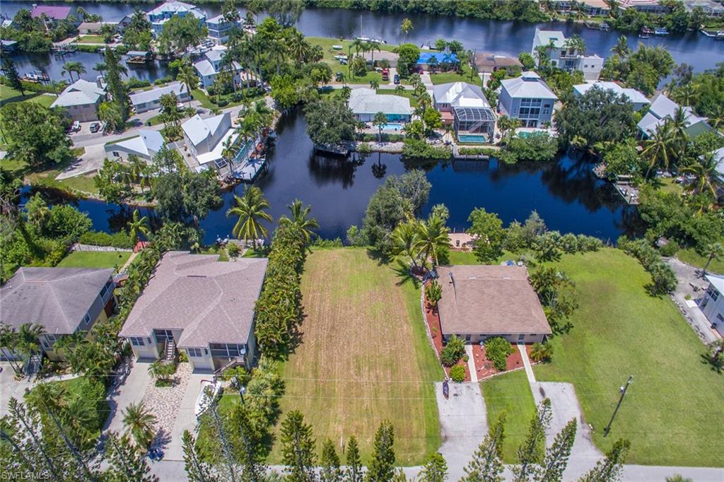 3665 Riviera Circle Bonita Springs, FL 34134 - Photo 13 of 24 an aerial view of house with yard swimming pool and outdoor seating