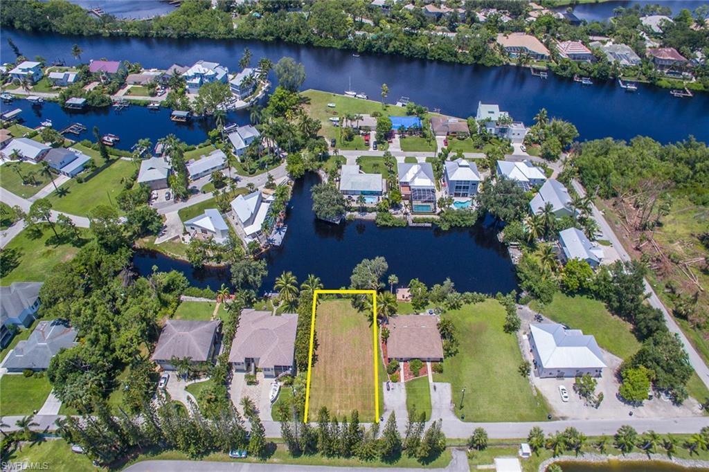 3665 Riviera Circle Bonita Springs, FL 34134 - Photo 14 of 24 an aerial view of ocean house with outdoor space and trees all around