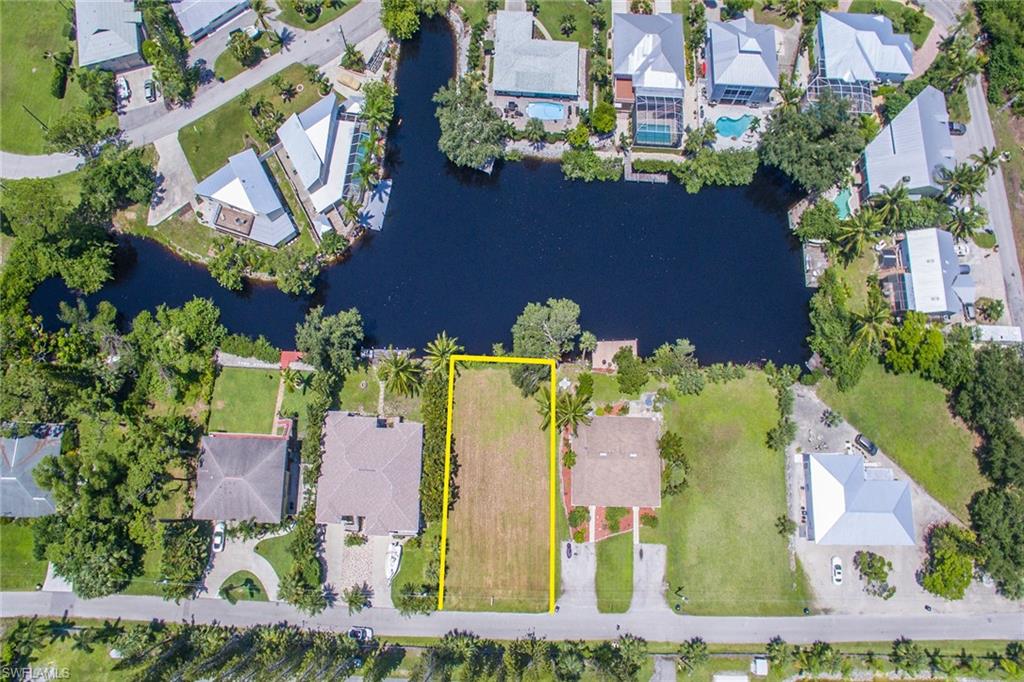 3665 Riviera Circle Bonita Springs, FL 34134 - Photo 4 of 24 an aerial view of a house with a yard and greenery