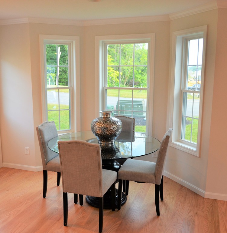 81 Riley Road, Unit 113 Tyngsborough, MA 01879 - Photo 4 of 14 a view of a dining room with furniture window and outside view