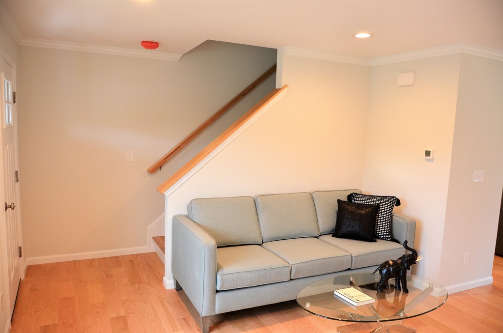 81 Riley Road, Unit 113 Tyngsborough, MA 01879 - Photo 8 of 14 a living room with furniture and a wooden floor