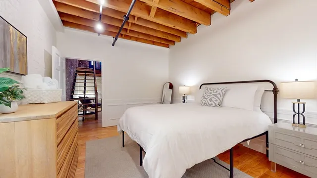 a bedroom with a bed and a chandelier