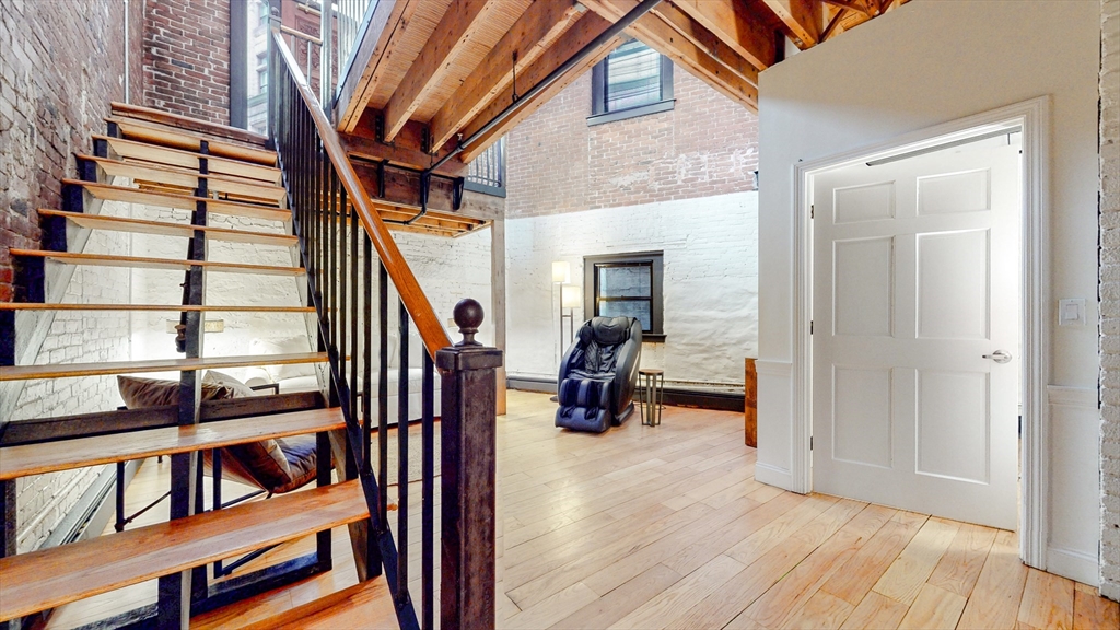 19 Stanhope Street, Unit 1A Boston, MA 02116 - Photo 12 of 21 a view of entryway and hall with wooden floor