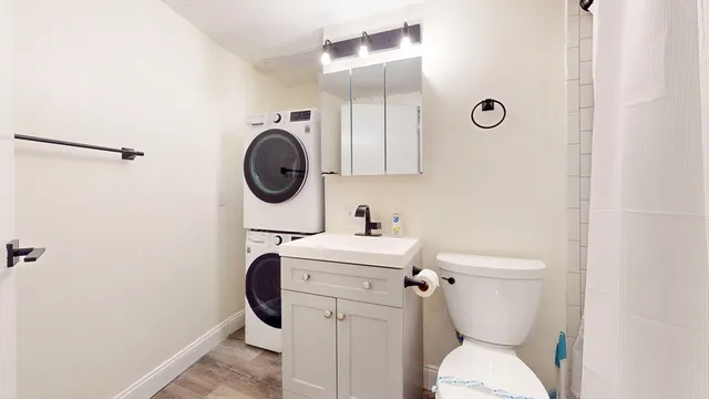 a bathroom with a sink mirror vanity and toilet