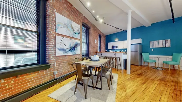 a view of a dining room with furniture window and wooden floor
