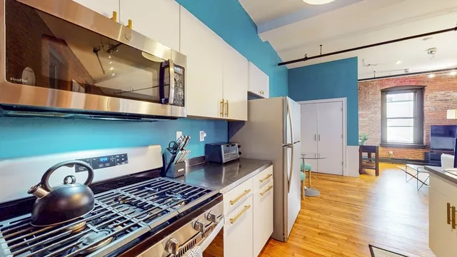 a kitchen with stainless steel appliances granite countertop a stove and a refrigerator