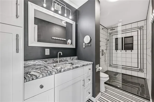 a bathroom with a sink a toilet and mirror