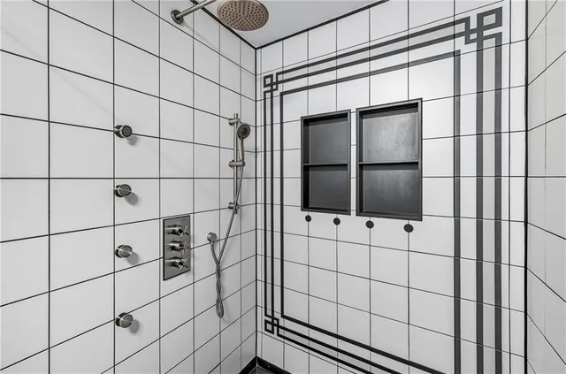 a bathroom with a shower and a window