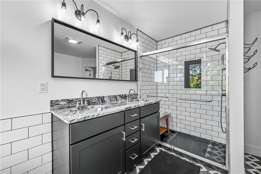 5237 Virginia Road Hermitage, PA 16148 - Photo 29 of 49 a bathroom with a shower sink and mirror