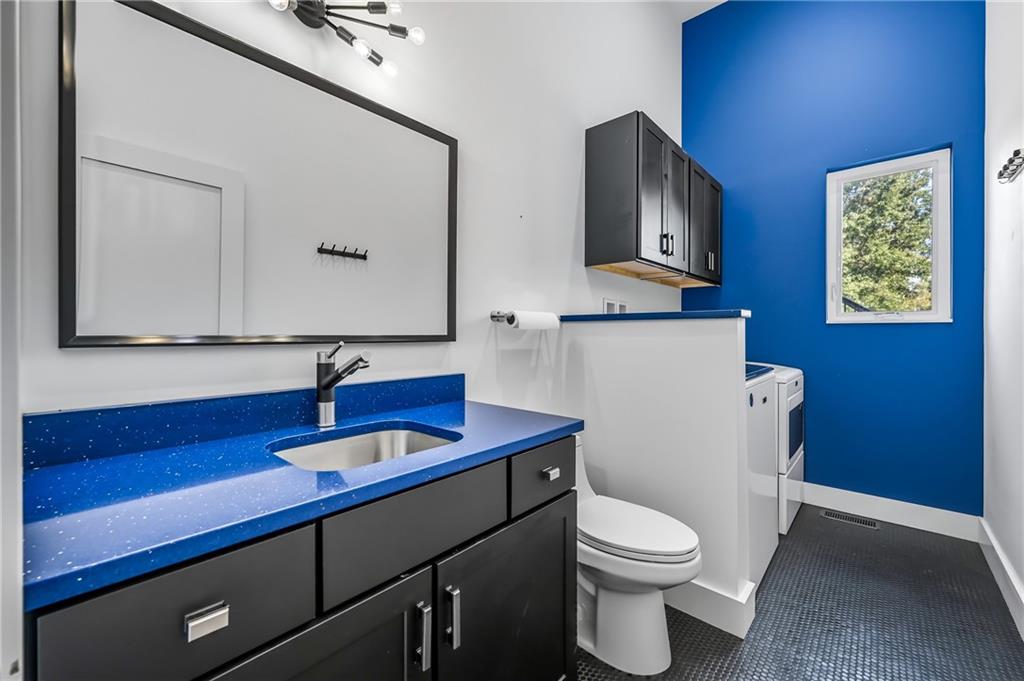 5237 Virginia Road Hermitage, PA 16148 - Photo 30 of 49 a bathroom with a toilet a sink and mirror