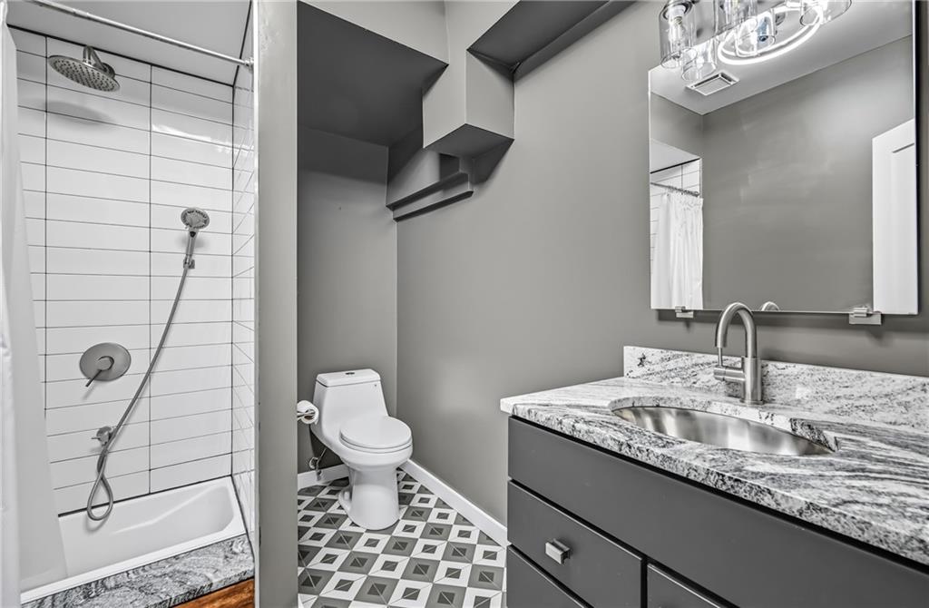 5237 Virginia Road Hermitage, PA 16148 - Photo 36 of 49 a bathroom with a granite countertop sink a toilet and a mirror