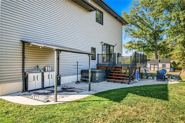 a view of a house with swimming pool and sitting area